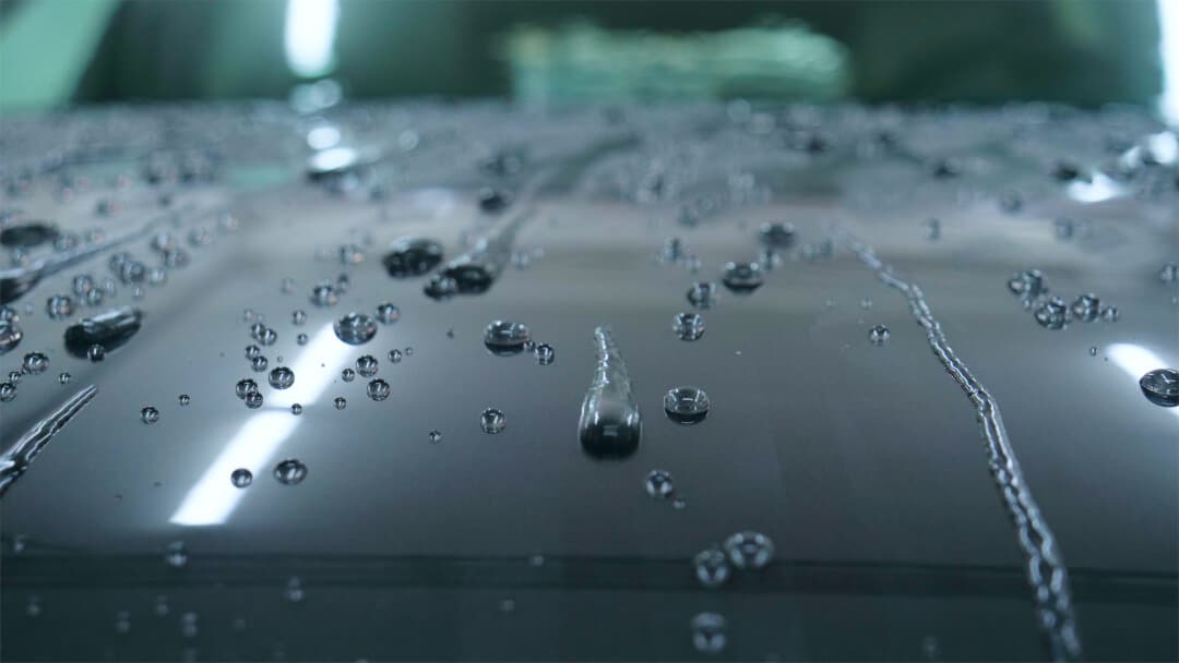 ceramic car wash beading water off hood of a car